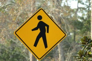 pedestrian-crossing-sign-in-front-of-trees