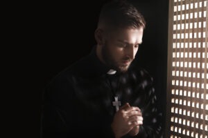 Priest In Confessional Booth
