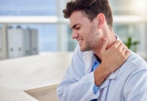 man-grabs-neck-in-pain