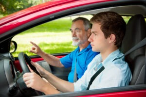 dad teaching son to drive
