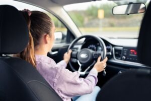 view of female rideshare driver from the back