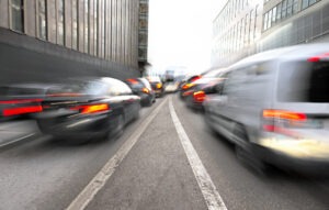 Multiple blurry cars speeding on the highway. What to do if you’re in a multi-vehicle crash in Michigan.