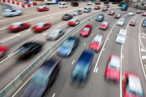 Multiple blurry cars speeding on the highway. Whose insurance pays when there’s a multi-vehicle pileup in Michigan?