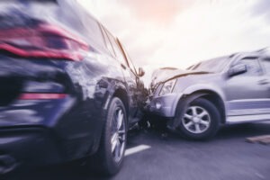 An action shot of a side-impace collision. Do I really need unlimited PIP coverage in Michigan?